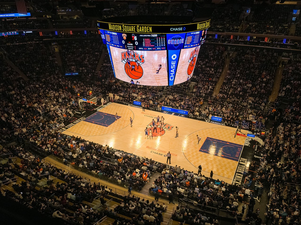 Specialty — elevated arena view during a basketball tip-off